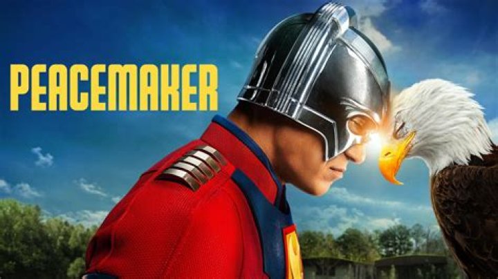 Peacermaker (John Cena) walks alongside a van in 'Peacemaker' (2022).